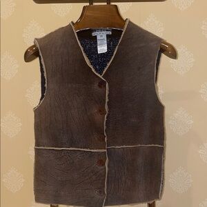 Brown Shearling Vest with Button Closure and knit background